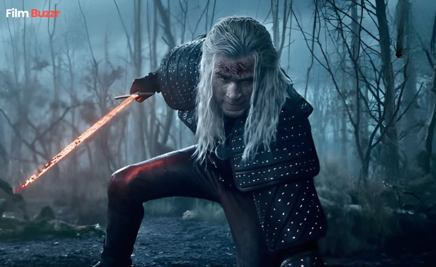 First official look at Liam Hemsworth as Geralt of Rivia in The Witcher Season 4, wearing Geralt’s iconic armor and holding a sword.