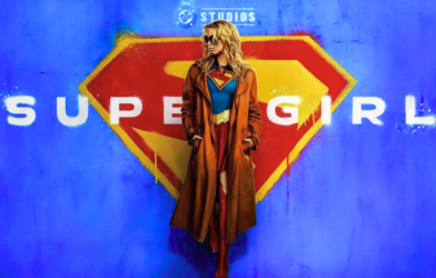 Milly Alcock as Supergirl and David Corenswet as Superman standing side by side on a Metropolis rooftop, showcasing the new DCU costumes