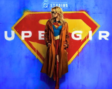 Milly Alcock as Supergirl and David Corenswet as Superman standing side by side on a Metropolis rooftop, showcasing the new DCU costumes
