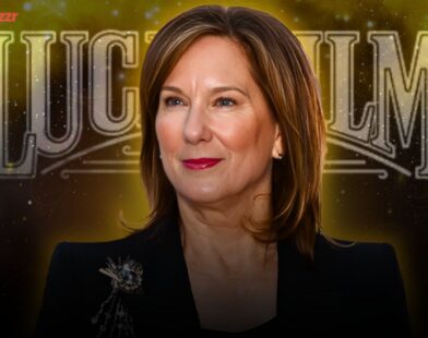 Kathleen Kennedy standing in front of a Lucasfilm or Star Wars backdrop during a media event.